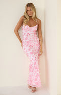 Model standing in a light pink maxi dress adorned with floral sequin embroidery and delicate straps suitable for a formal dance